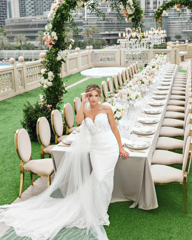 Outdoor wedding with floral arch and elegant reception table by Wedding Planner Dubai